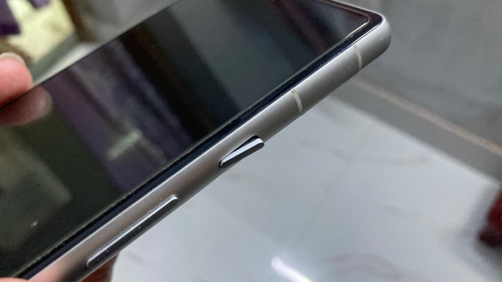 Google Pixel 7a power button showing signs of wear after three years